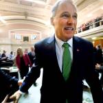 Gov. Jay Inslee heads out after giving his State of the State address to a joint session of the Legislature on Tuesday in Olympia. Inslee, who is mulling a 2020 White House bid, highlighted his clean energy agenda in the annual speech. (AP Photo/Elaine Thompson)