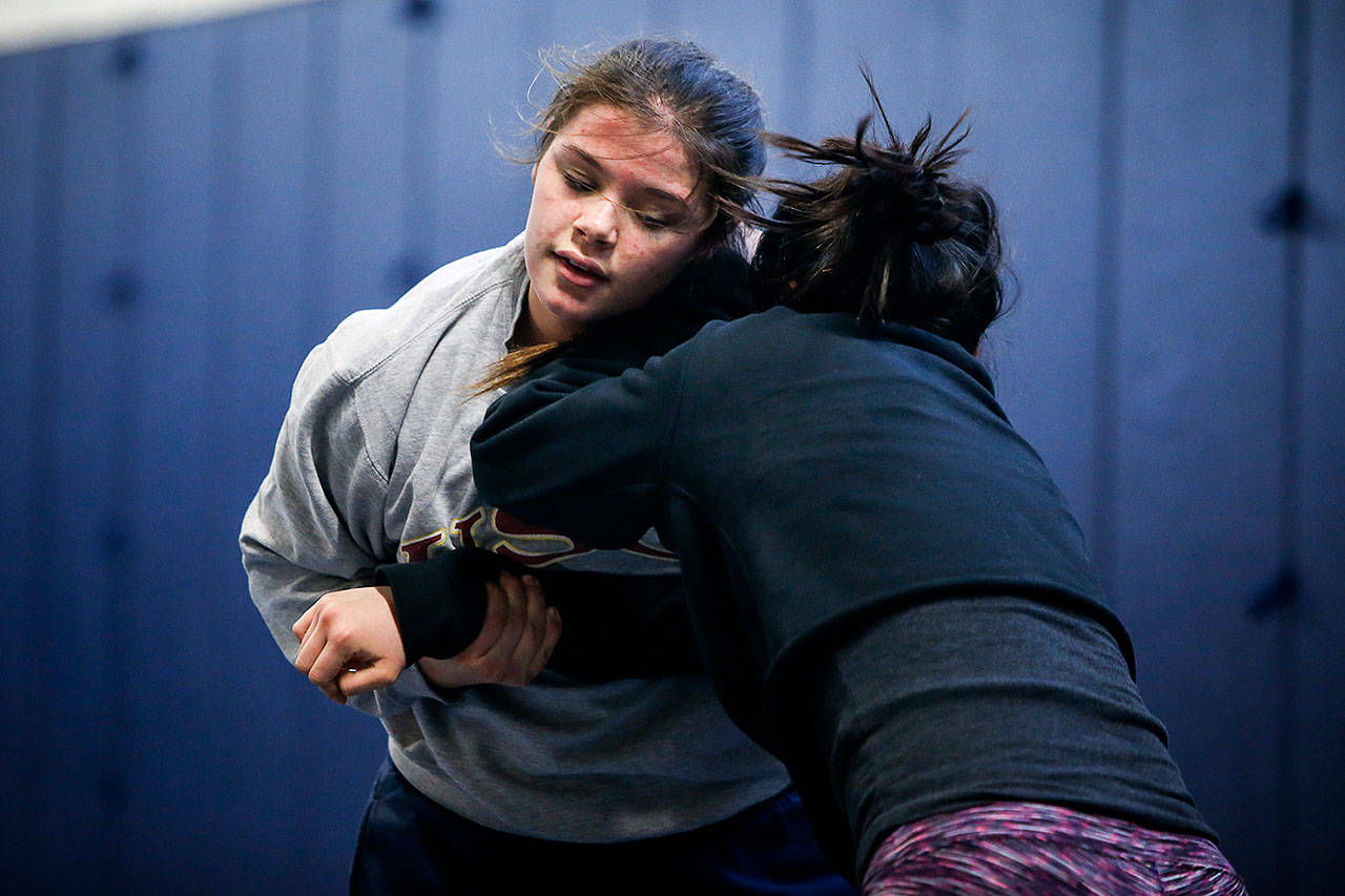 Kiley Hubby (left) trains with teammate Cassy Vando during a practice on Jan. 4, 2018, at Glacier Peak High School. Hubby, a junior currently ranked third in the nation at 152 pounds, wrestles for Lake Stevens this season. (Ian Terry / The Herald)