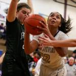 Lake Stevens Raigan Reed (right) look to score with Jacksons Olivia Skibiel defending during the Vikings 62-39 win Tuesday night at Lake Stevens High School. (Kevin Clark / The Herald)