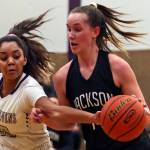 Lake Stevens Raigan Reed (left) reaches to dislodge the ball from Jacksons Alexa Martin during the Vikings 62-39 win Tuesday night at Lake Stevens High School. (Kevin Clark / The Herald)