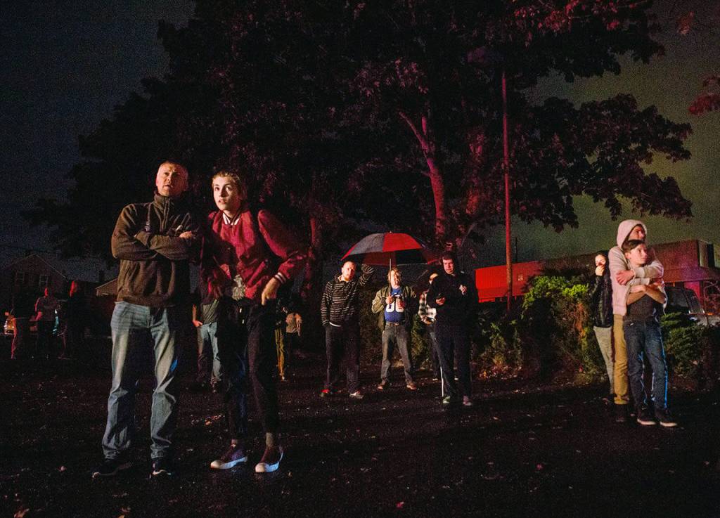People gather to watch as the Judd & Black appliance store is engulfed in flames on Sept. 21, 2018, in Everett. (Olivia Vanni / Herald file)