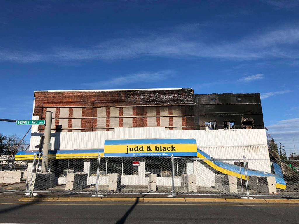 Almost four months after a fire at Judd & Black in Everett, police announced it was caused by arson. One lane of northbound Maple Street was still closed Wednesday at Hewitt Avenue. (Caleb Hutton / The Herald)