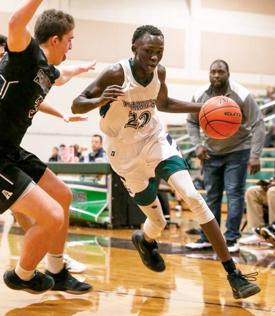 Edmonds-Woodways Mutdung Bol (right) controls the ball with Arlingtons Griffin Gardoski defending during a game on Jan. 9, 2019, at Edmonds-Woodway High School. (Kevin Clark / The Herald)