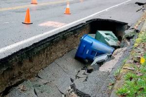 Large sinkholes appear on road after water main breaks