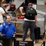 A TSA worker helps passengers at the Salt Lake City International Airport on Wednesday. The government shutdown has generated an outpouring of generosity to TSA agents and other federal employees who are working without pay. (AP Photo/Rick Bowmer)