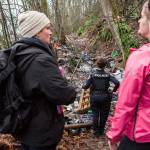 Catholic Community Services case manager Rhonda Polly (left) chats with social worker Kelli Roark (right) as they check on encampments during the annual Point in Time count on Wednesday in Everett. (Olivia Vanni / The Herald)