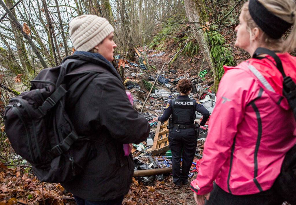 Catholic Community Services case manager Rhonda Polly (left) chats with social worker Kelli Roark (right) as they check on encampments during the annual Point in Time count on Wednesday in Everett. (Olivia Vanni / The Herald)