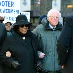 Following a Martin Luther King Jr. prayer service Monday at Zion Baptist Church in Columbia, South Carolina, New Jersey Sen. Cory Booker, D-New Jersey (left) and Sen. Bernie Sanders, I-Vermont., walk with NAACP President Brenda Murphy during a march to the Statehouse. (AP Photo/Meg Kinnard)