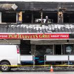 Everett fire investigators inspect Harveys Pub & Grill on Sunday. (Olivia Vanni / The Herald)