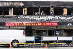 Everett fire investigators inspect Harveys Pub & Grill on Sunday. (Olivia Vanni / The Herald)