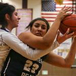 Glacier Peaks Tiara Hollimon (right) gathers a rebound with Lake Stevens Carmen Long reaching in during the Grizzlies 67-48 win over the Vikings on Tuesday night at Lake Stevens High School. (Kevin Clark / The Herald)