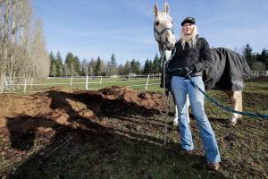 With her horse Joe next to her, Melonie Rainey of White Birch Farm on the Tulalip Indian Reservation talks about her participation in the Conservation Districts horse manure spreading program Monday, Jan. 28, 2019. The program helps horse owners keep manure under control, turn it into fertilizer and use it on their pastures. (Andy Bronson / The Herald)