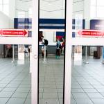 This 2017 photo shows a sliding door closing as travelers stand in a security line at LaGuardia Airport in New York. (David Williams/Bloomberg)