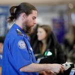 Passengers stand in line as they wait to pass through a TSA security checkpoint at LaGuardia airport on Jan. 7 in New York. (AP Photo/Frank Franklin II)
