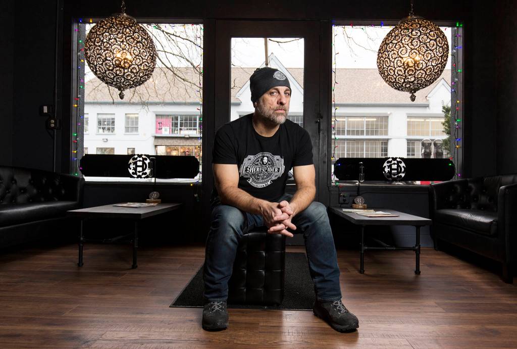 <a href="http://bbjtoday.com/blog/hard-rocking-cidery-the-third-to-open-in-bellingham-last-year/36667/" target="_blank">Herbs Cider</a> owner Tim Alexander sits inside the tasting room downtown at 1228 Bay Street on Dec. 14, 2018, in Bellingham. (Andy Bronson / The Herald)