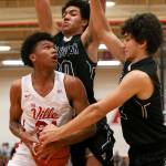 Marysville Pilchucks RaeQuan Battle gathers with Arlingtons Will Abram (back) and Arlingtons Michael Tsoukalas defending at Marysville Pilchuck High School on Jan. 23. The Tomahawks won 60-52. (Kevin Clark / The Herald)