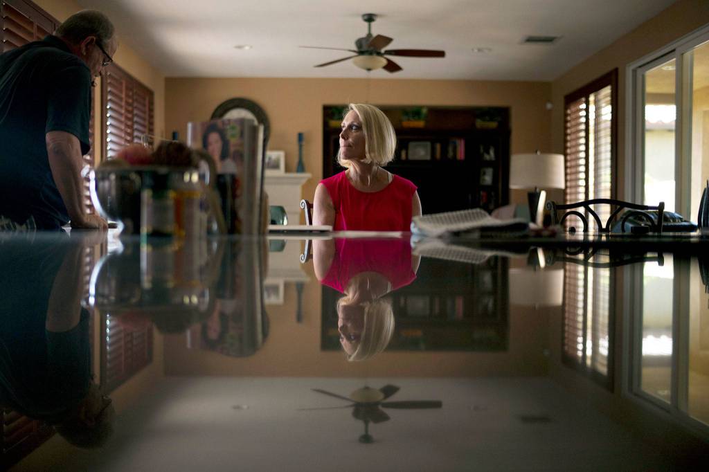 Mollie Biggers (center) looks at her husband, Doug, as he heads to his home office to take a business call in La Quinta, California. The Biggers went broke sending their son, Landon, to every type of treatment they could find, including one that promised to teach responsibility through raising a puppy. But now there isnt much left to do but stare at the box of his ashes on a shelf above the television, hidden behind a smiling photo of the family they always wanted but never really were. The 20-year-old died of a heroin overdose in 2017. (AP Photo/Jae C. Hong)