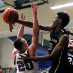 Jacksons Jaylen Searles (right) blocks a shot attempt by Glacier Peaks Fletcher Douglas during a Wesco 4A boys basketball game Wednesday at Glacier Peak High School in Snohomish. Searles was called for a foul on the play, but the Timberwolves beat the Grizzlies 47-44. (Kevin Clark / The Herald)