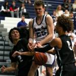 From left, Jacksons Jesse Hoiby, Glacier Peaks Noah Forman and Jacksons Christian Liddell scramble for a loose ball during a Wesco 4A boys basketball game Wednesday at Glacier Peak High School in Snohomish. Jackson beat the Grizzlies 47-44. (Kevin Clark / The Herald)