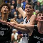 Jacksons Christian Liddell (left-right) Glacier Peaks Noah Forman and Jacksons Carter Korab look to rebound off a free throw at Glacier Peak High School Friday night in Snohomish on January 30, 2019. The Timberwolves won 47-44. (Kevin Clark / The Herald)
