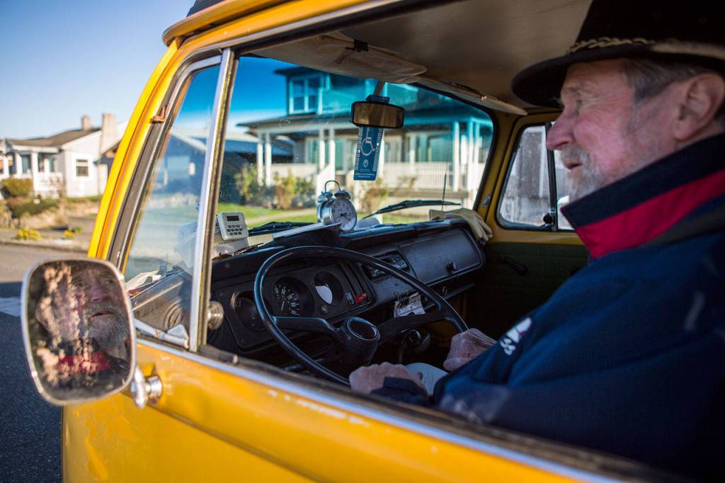 Steve Bell sits in the drivers seat of his 1976 Volkswagen Westfalia van, which is a fixture along the Edmonds waterfront. (Olivia Vanni / The Herald)