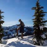 Kyle James looks out at Stevens Pass from a ridge line on the Skyline Lake Trail. (Olivia Vanni / The Herald)