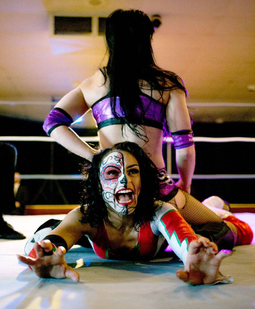 Thunder Rosa, bottom, and Priscilla Kelly in the ring at a monthly independent wrestling match at Normanna Lodge by Everett event promoter Without a Cause. (Vitz Photos)