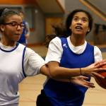 Grace Academys E. Fredrickson (left) reaches in as her sister, A. Fredrickson, looks to score during practice on Jan. 30 in Marysville. (Kevin Clark / The Herald)