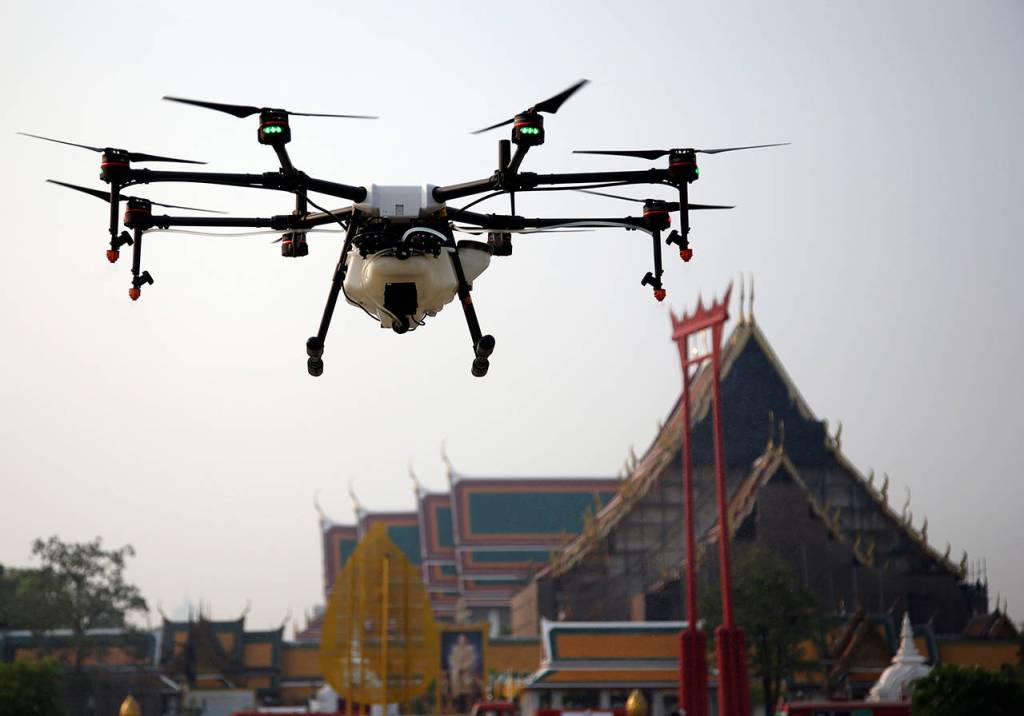 A drone is flown over the Suthat Temple in Bangkok, Thailand, Thursday. Bangkoks municipal government displayed six drones that will be used to spray water over the city to help ease high levels of pollution. More than 400 schools in Thailands capital were shut for the rest of the week Wednesday due to increasing concern over dangerously unhealthy air pollution. (AP Photo/Sakchai Lalit)