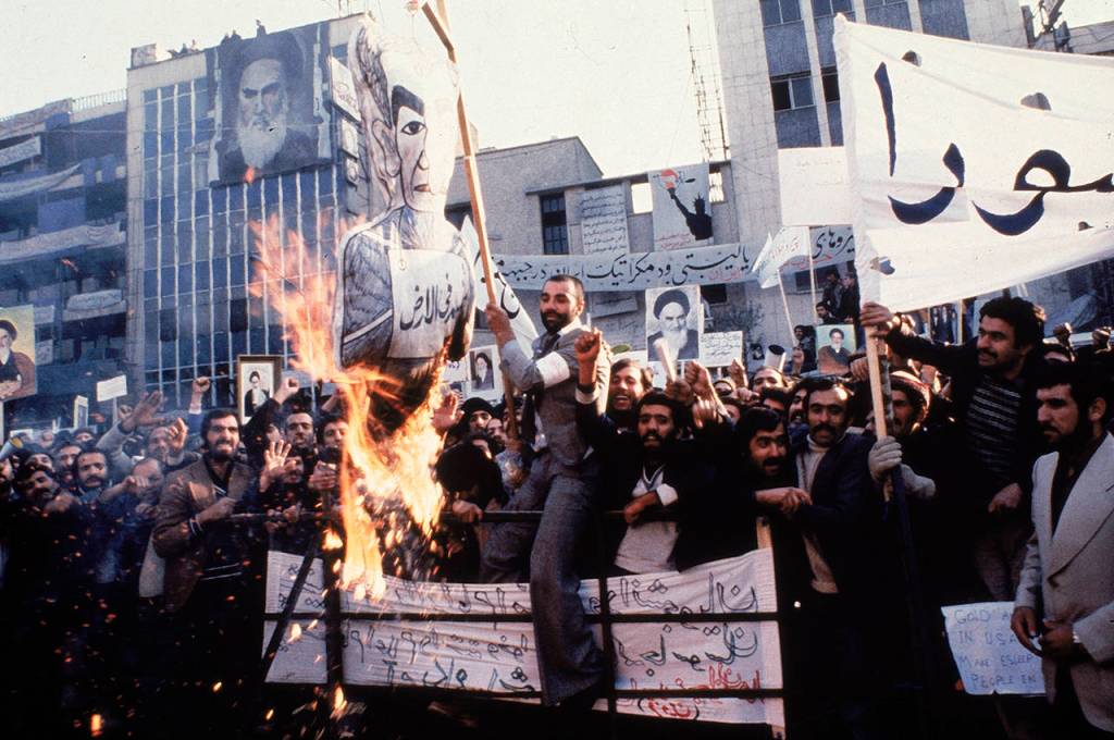 In an undated photo from 1979, protestors burn an effigy of Shah Mohammad Reza Pahlavi during a demonstration in front of the U.S. Embassy in Tehran, Iran. (AP Photo, File)