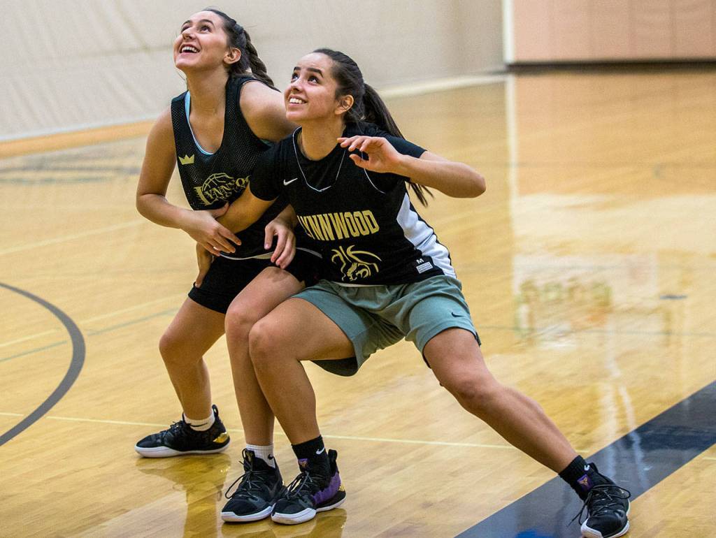 Lynnwood junior Amayah Kirkman (right) smiles with her teammate during practice on Jan. 31, 2019, at Lynnwood High School in Bothell. (Olivia Vanni / The Herald)