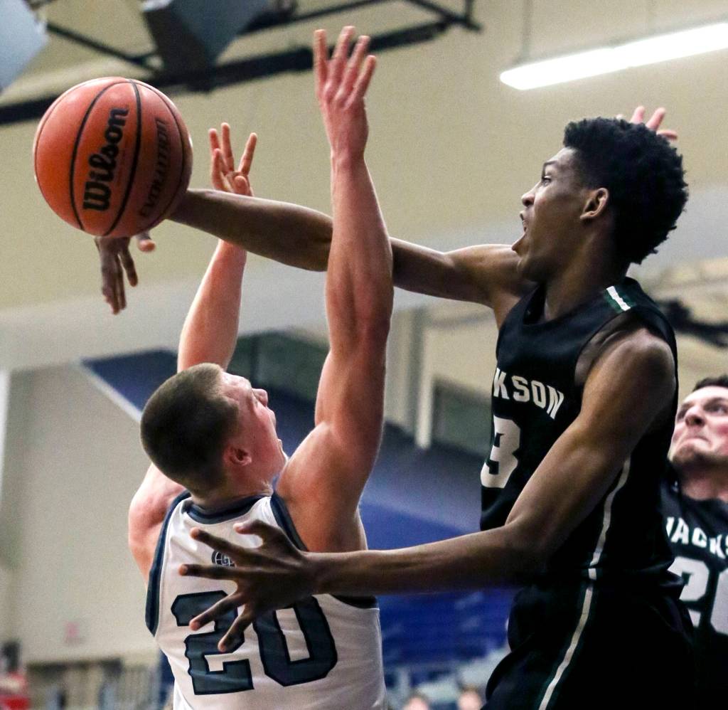 Jacksons Jaylen Searles blocks and fouls Glacier Peaks Fletcher Douglas at Glacier Peak High School in Snohomish on Jan. 30. The Timberwolves won 47-44. (Kevin Clark / The Herald)