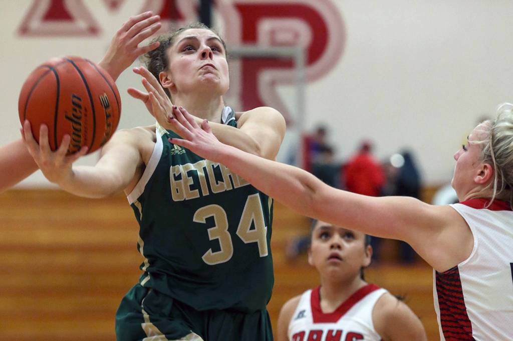 Marysville-Getchells Maddy Grandbois attempts a shot with Marysville Pilchucks MacKenzie Konsor (right) reaching in at Marysville Pilchuck High School on Jan. 25. The Chargers won 62-15. (Kevin Clark / The Herald)