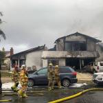 Firefighters respond to the scene of a plane crash Sunday at a home in Yorba Linda, California. A twin-engine Cessna 414A crashed in Yorba Linda shortly after taking off from the nearby Fullerton Municipal Airport. The Orange County Fire Authority said the crash in a Yorba Linda neighborhood ignited a fire that burned the house Sunday afternoon. (AP Photo/Alex Gallardo)