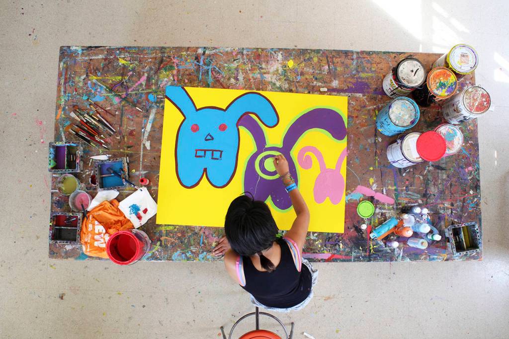 Inocente, an undocumented teen, paints Masters of Disguise in the film Inocente. (Sean Fine)