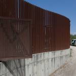 A U.S. Customs and Border Patrol vehicle passes along a section of border levee wall in Hidalgo, Texas, in 2017. The U.S. government is preparing to begin construction of more border walls and fencing in South Texas Rio Grande Valley, likely on federally-owned land set aside as wildlife refuge property. Heavy construction equipment is supposed to arrive starting Monday. A photo posted by the nonprofit National Butterfly Center shows an excavator parked on its property. (AP Photo/Eric Gay, File)