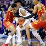 Washingtons Jaylen Nowell (center) is double teamed by USC defenders Kevin Porter Jr. (left) and Shaqquan Aaron during the second half of a college basketball game Wednesday in Seattle. (AP Photo/Elaine Thompson)