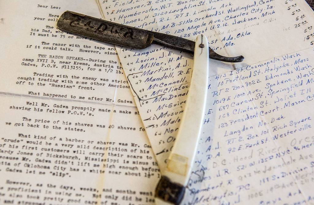 A razor that Frank Gadwa used to give fellow soldiers shaves sits next to list of solider names and the prices they paid for their shaves. (Olivia Vanni / The Herald)