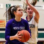 North Creeks Kelsey Hudson (left) drives against Jacksons Alexa Martin during a 4A Wes-King District Tournament play-in game Thursday at Jackson High School in Mill Creek. Hudson scored 33 points and the Jaguars won 84-70. Jacksons season ends at 15-5. (Kevin Clark / The Herald)