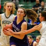 North Creeks Brandi White drives as Jacksons Megan Mattison (left) and Jacksons Mackendra Konig defend during a 4A Wes-King District Tournament play-in game Thursday at Jackson High School in Mill Creek. North Creek beat the Timberwolves 84-70. (Kevin Clark / The Herald)