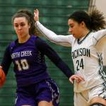 North Creeks Lexi Ducheane (left) brings the ball upcourt with Jacksons Jaelen Williams defending during a 4A Wes-King District Tournament play-in game Thursday at Jackson High School in Mill Creek. North Creek beat the Timberwolves 84-70. (Kevin Clark / The Herald)