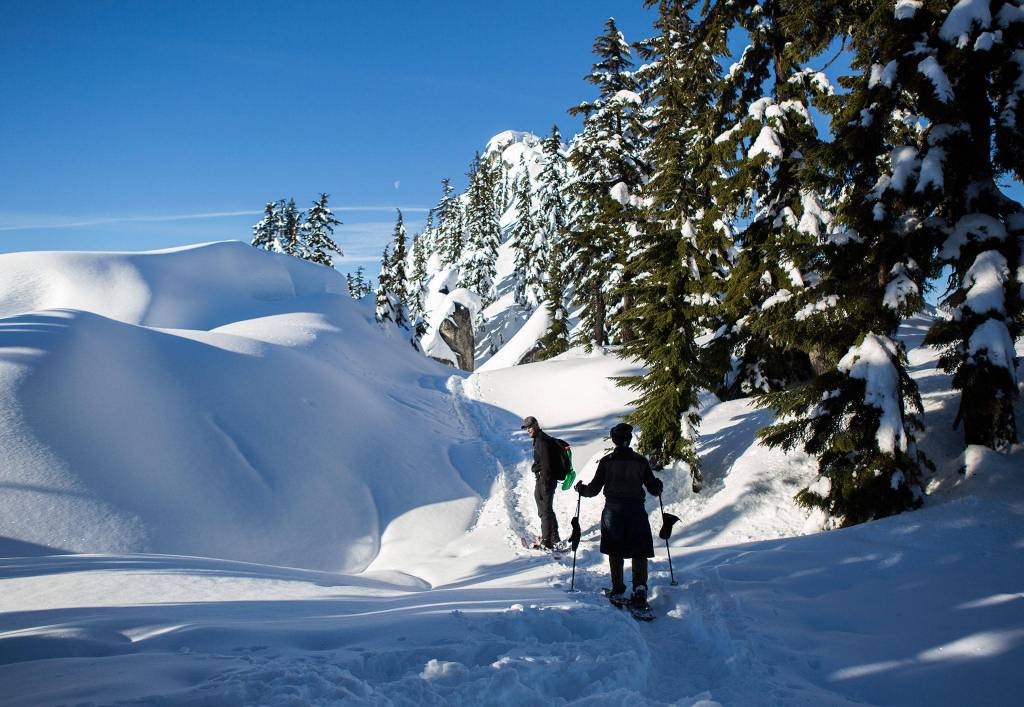 Don Sarver (left) and Kyle James (right) snowshoe on the Skyline Lake Trail on Jan. 26 in Leavenworth. (Olivia Vanni / The Herald)