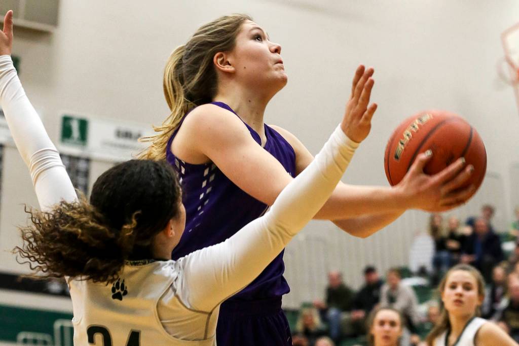 North Creeks Caitlin Monten attempts a shot with Jacksons Jaelen Williams defending at Jackson High School in Mill Creek on Feb. 7. The Jaguars won 84-70. (Kevin Clark / The Herald)