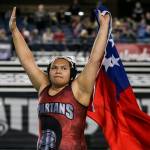 Stanwoods Chanel Siva celebrates with the Samoan flag after her win over Thomas Jeffersons Goddess Ma`alona-Fal in the 235 weight class to win a state title Saturday night during the Mat Classic XXXI at the Tacoma Dome. (Kevin Clark / The Herald)