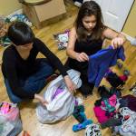 Diane Bradford (left) and her daughter Sierra Lindenstein, 11, <a href="https://www.heraldnet.com/news/does-declutter-diva-marie-kondo-spark-joy-or-misery/" target="_blank">sort through clothing</a> at their home on Jan. 20 in Lynnwood. (Olivia Vanni / The Herald)