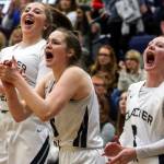 Players cheer the action on the court at Glacier Peak High School in Snohomish on Feb. 14. The Grizzles won 57-37. (Kevin Clark / The Herald)