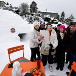 Neighbors sing the <a href="https://www.heraldnet.com/news/another-storm-brings-crashes-mounds-of-trash-and-an-igloo/" target="_blank">Igloo Hut Song</a> at Rucker Park on Feb. 11 in Everett. The song was written by Cherie Hansen (center) and sung to the tune of O Christmas Tree. (Andy Bronson / The Herald)