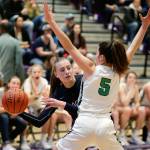 Glacier Peaks Madison Rubino tries to pass around Woodinvilles Katie Minnehan during the Class 4A Wes-King Bi-District Tournament title game Monday, Feb. 18, at North Creek High School. The fourth-ranked Grizzlies fell to the top-ranked Falcons 64-54. (Andy Bronson / The Herald)