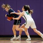 Glacier Peaks Sydney Guffey strips the ball away from two Woodinville players. (Andy Bronson / The Herald)