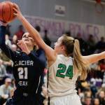 Woodinvilles Mia Hughes blocks Glacier Peaks Sydney Guffey. (Andy Bronson / The Herald)